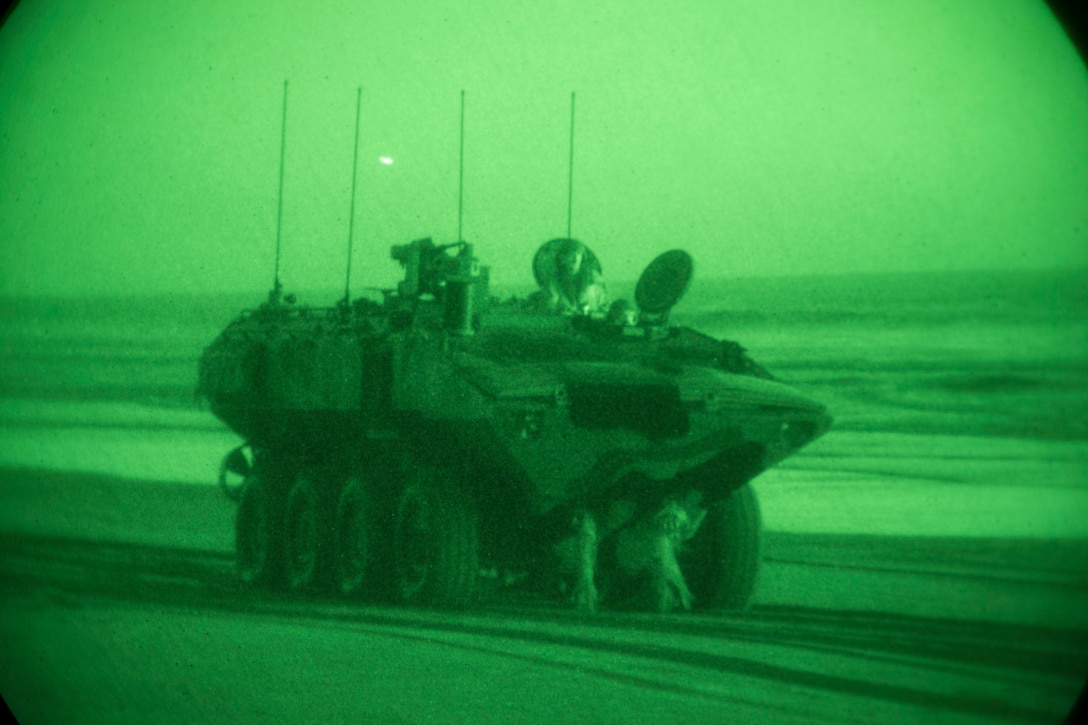 U.S. Marines with Amphibious Vehicle Test Branch, Marine Corps Tactical Systems Support Activity, drive a new Amphibious Combat Vehicle along the beach during low-light surf transit testing at AVTB Beach on Marine Corps Base Camp Pendleton, California, Dec. 18, 2019. The test was designed to assess and verify how well Marines can interface with the vehicle and operate at night. The ACV is an eight-wheeled armored personnel carrier designed to fully replace the Corps’ aging fleet of Amphibious Assault Vehicles.  (U.S. Marine Corps photo by Lance Cpl. Andrew Cortez)