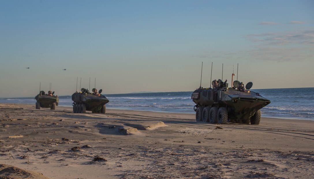 U.S. Marines with Amphibious Vehicle Test Branch, Marine Corps Tactical Systems Support Activity, drive new Amphibious Combat Vehicles along the beach during low-light surf transit testing at AVTB Beach on Marine Corps Base Camp Pendleton, California, Dec. 18, 2019. The test was designed to assess and verify how well Marines can interface with the vehicle and operate at night. The ACV is an eight-wheeled armored personnel carrier designed to fully replace the Corps’ aging fleet of Amphibious Assault Vehicles.  (U.S. Marine Corps photo by Lance Cpl. Andrew Cortez)
