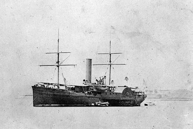 A 1860s-era side-wheel steamship with two masts sits in water offshore.