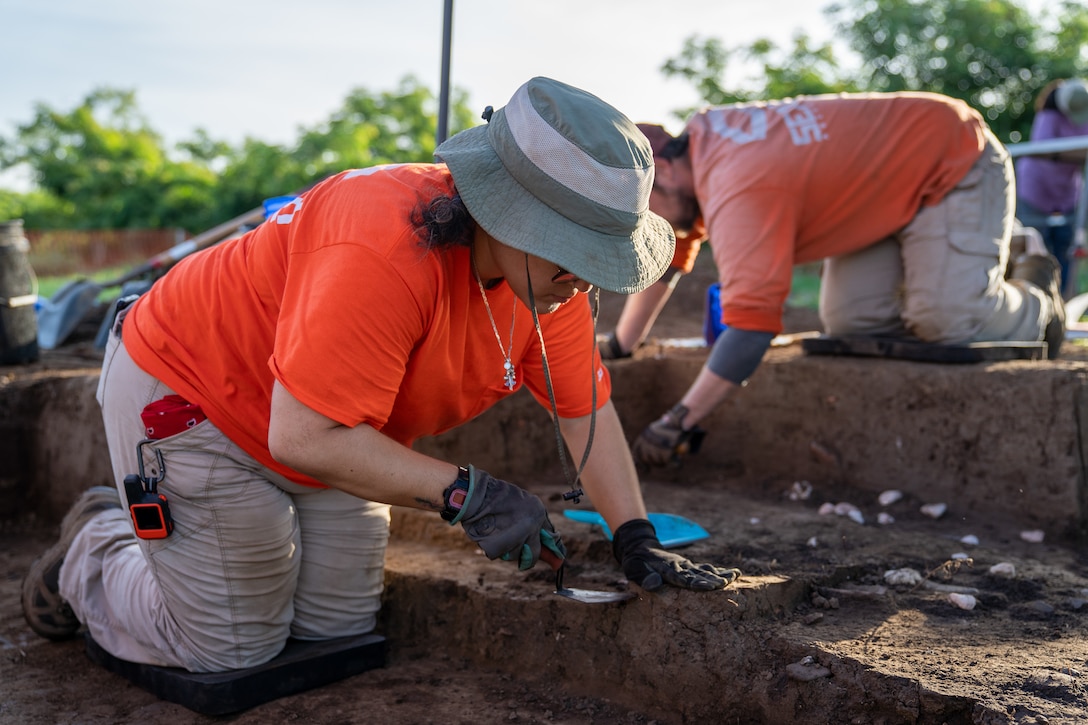 Archeologist looking at pieces on the ground