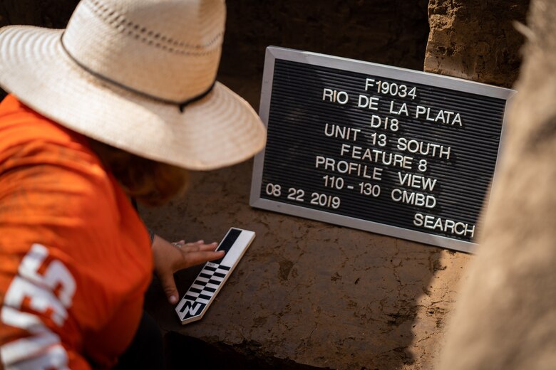 Archeologist looking at pieces on the ground