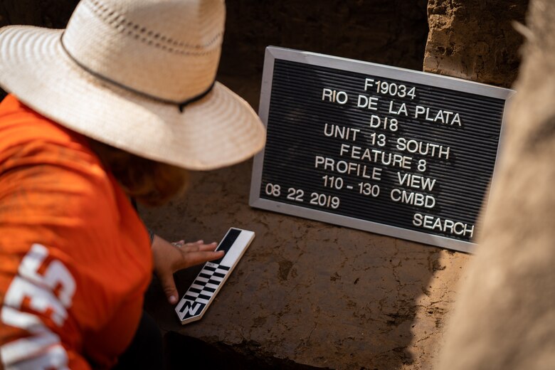 Archeologist looking at pieces on the ground