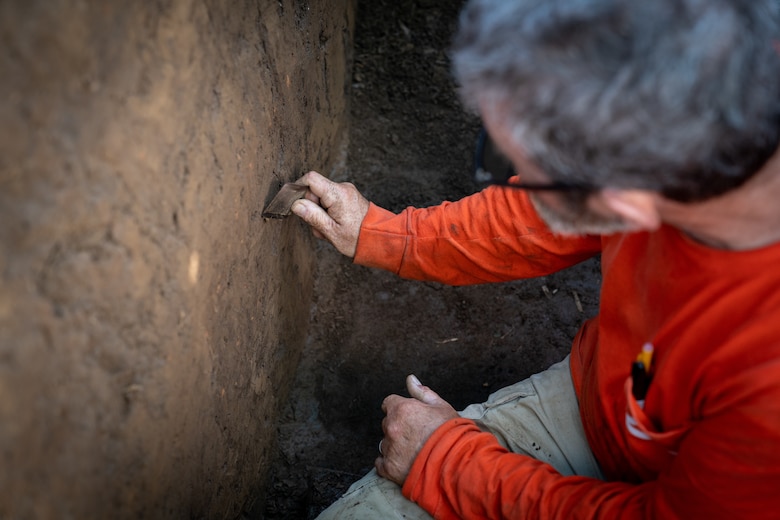 Archeologist looking at pieces on the ground