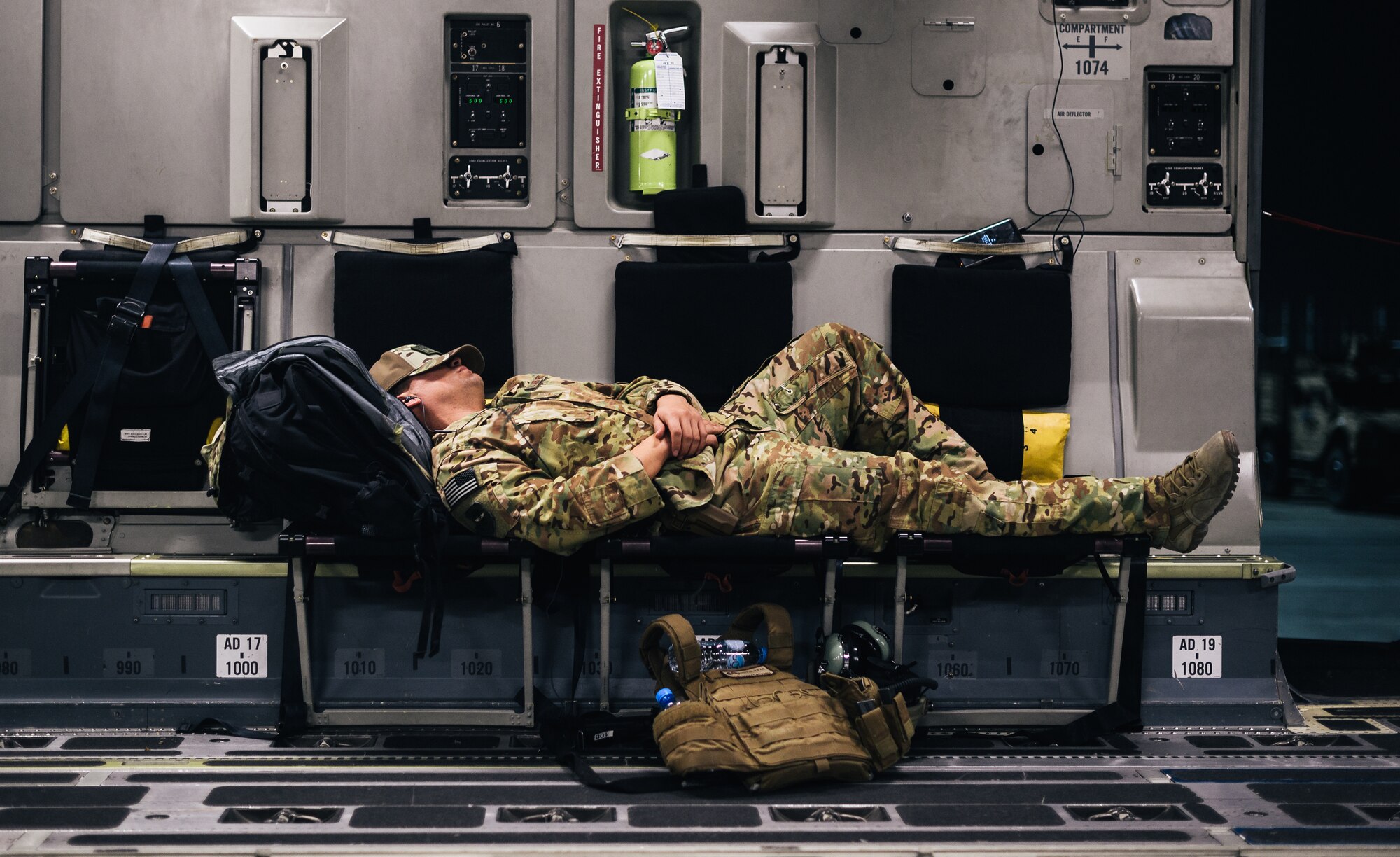 A U.S. Air Force Airman sleeps inside a C-17 Globemaster III during a flight over an undisclosed location in support of Operation Freedom Sentinel, Jan. 22, 2018. Airmen supporting OFS work to prevent Afghanistan from becoming a safe haven for al Qaeda and international extremist groups. (U.S. Air Force illustration)