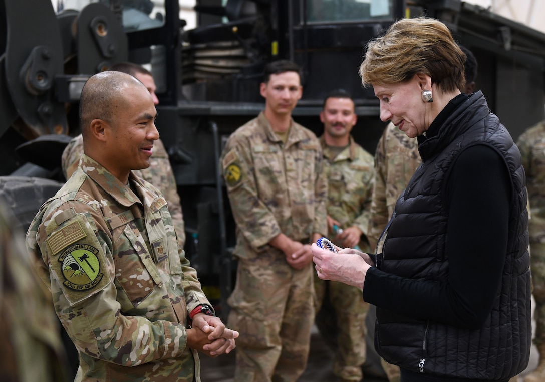 U.S. Air Force Tech. Sgt. Siden Yem, 724th Expeditionary Air Base Squadron material management section chief, gives Secretary of the Air Force Barbara M. Barrett a paracord bracelet he made at Nigerien Air Base 201, Niger, Dec. 21, 2019. During her first visit to the African continent since taking office in October, Barrett’s focus was centered solely on the U.S. service members deployed there. (U.S. Air Force photo by Staff Sgt. Alex Fox Echols III)