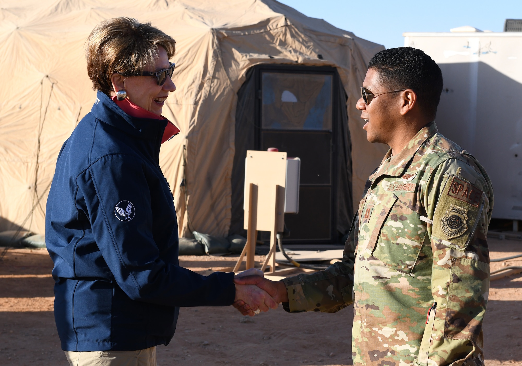 Secretary of the Air Force Barbara M. Barrett meets Capt. Marcus Fairchild, 4th Expeditionary Space Control Flight commander, during her visit to Nigerien Air Base 201, Niger, Dec. 21, 2019. Fairchild and his team are among the first deployed members of the newly created sixth branch of the United States military: the Space Force. (U.S. Air Force photo by Staff Sgt. Alex Fox Echols III)