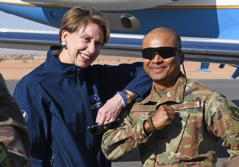 Secretary of the Air Force Barbara M. Barrett and U.S. Air Force Tech. Sgt. Siden Yem, 724th Expeditionary Air Base Squadron material management section chief, show off their paracord bracelets he made at Nigerien Air Base 201, Niger, Dec. 21, 2019. During her first visit to the African continent since taking office in October, Barrett's focus was centered solely on the U.S. service members deployed there. (U.S. Air Force photo by Staff Sgt. Alex Fox Echols III)