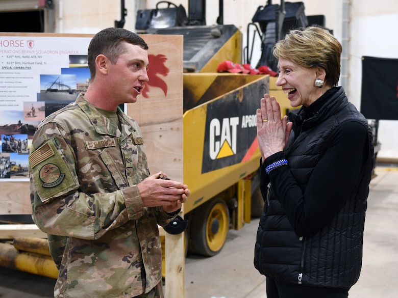 Secretary of the Air Force Barbara M. Barrett receives a coin made from a core sample of the flightline from an 819th Expeditionary Rapid Engineer Deployable Heavy Operational Repair Squadron Engineer Airmen during her visit to Nigerien Air Base 201, Niger, Dec. 21, 2019. During her first visit to the African continent since taking office in October, Barrett's focus was centered solely on the U.S. service members deployed there. (U.S. Air Force photo by Staff Sgt. Alex Fox Echols III)