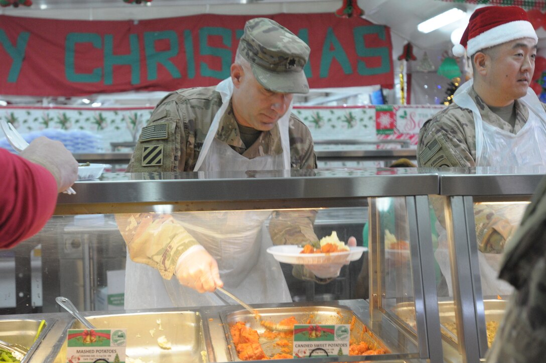 77th Sustainment Brigade continue the tradition of serving a holiday meal