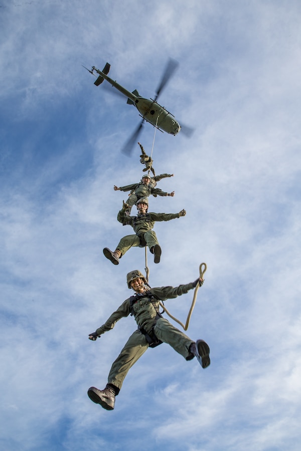 A UH-1Y Venom with Marine Light Attack Squadron 469 lifts U.S. Marines into the air, using special patrol insertion/extraction harnesses, during a helicopter rope suspension technician  masters course at Marine Corps Base Camp Pendleton, California, Dec. 11, 2019. The course provided the students the ability to conduct HRST techniques safely on their own, including SPIE rigging, fast roping, and rappelling from helicopters, enabling their units to be able to insert and extract anywhere, even when a landing zone is unavailable.