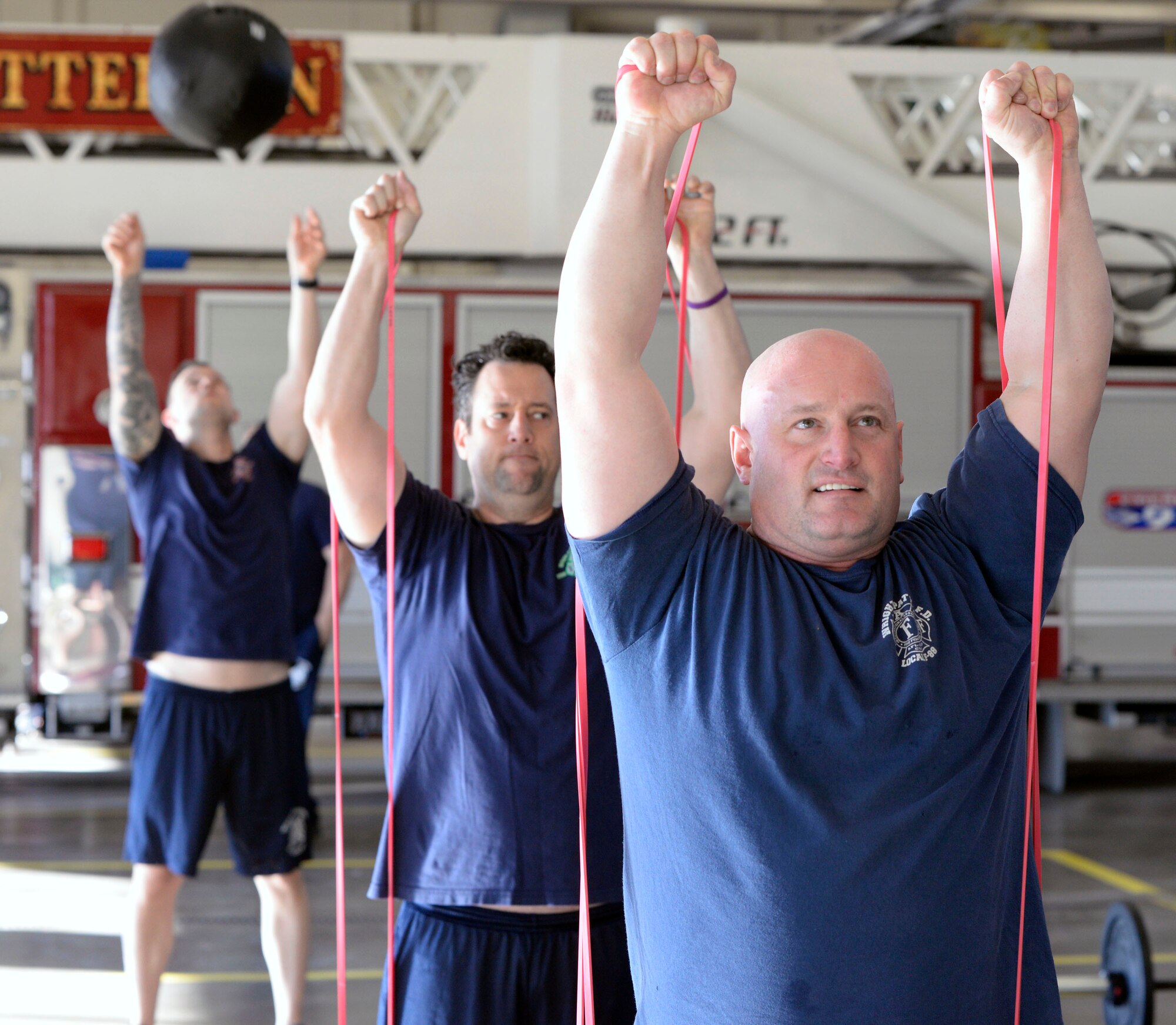Left to right, 788th Civil Engineer Squadron Fire Captain Steven McKee, and firefighters Shaun Bigler and Ben Cully work together to become peer fitness trainers at Fire Station 1 on Wright-Patterson Air Force Base, Ohio on Thursday, December 19, 2019. Firefighters from the 72nd Air Base Wing Civil Engineer Squadron, Tinker AFB, Oklahoma and 66th Civil Engineer Squadron Hanscom AFB, Massachusetts, joined in the training which is aiming to double the number of certified peer trainers at fire stations. (U.S. Air Force Photo by Ty Greenlees)