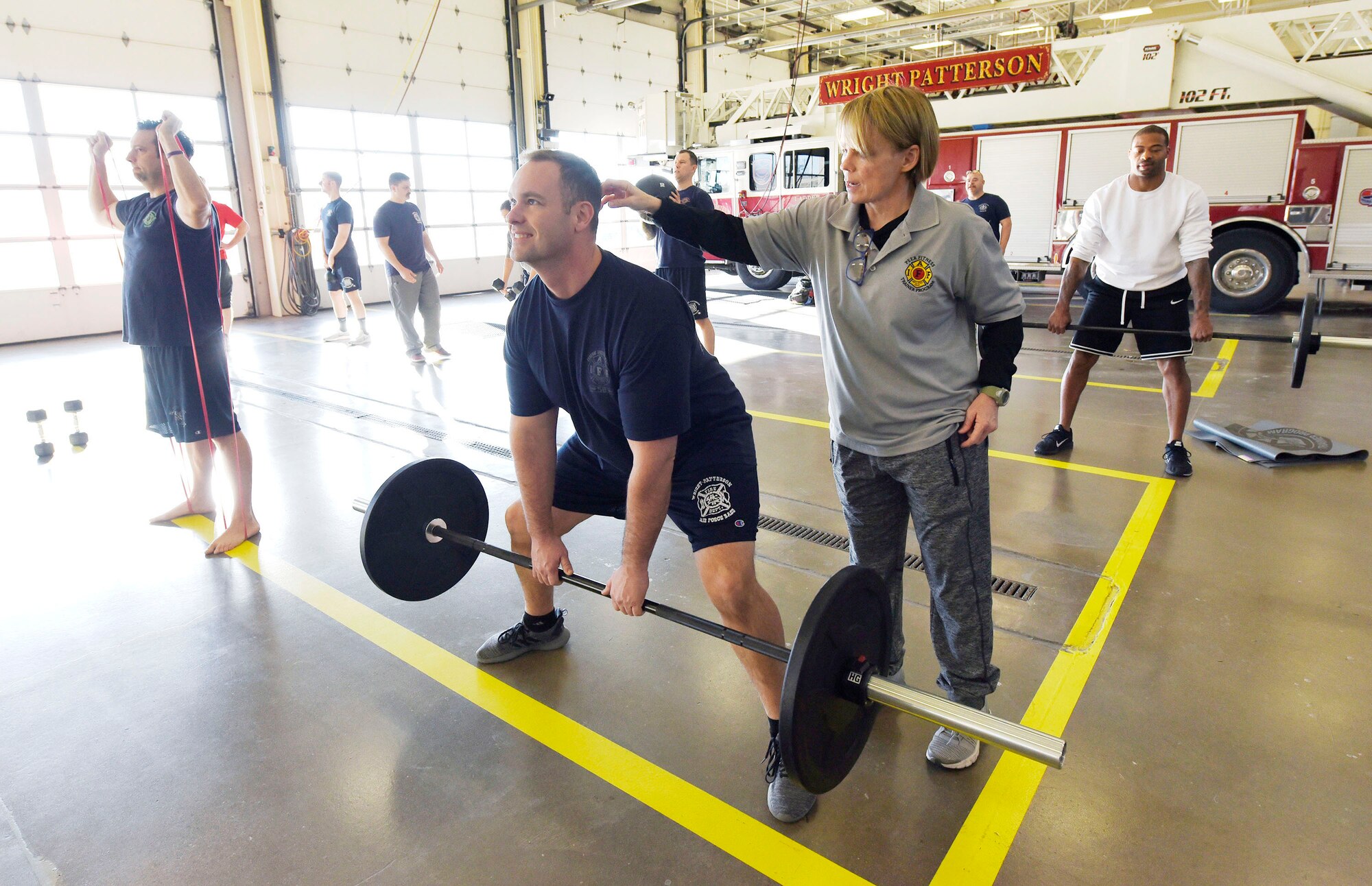 Peer Fitness trainer Sue Shepherd, right, works with Andy Short, 788th Civil Engineer Squadron firefighter, at Wright-Patterson Air Force Base, Ohio on Thursday, December 19, 2019. Firefighters from Wright-Patt, the 72nd Air Base Wing Civil Engineer Squadron, Tinker AFB, Oklahoma and 66th Civil Engineer Squadron Hanscom AFB, Massachusetts, joined in the training which is aiming to double the number of certified peer trainers at fire stations. (U.S. Air Force Photo by Ty Greenlees)