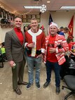 Maj. Patrick Skehan, Staff Sgt. McCoy Herold and Staff Sgt. Andrew Miller pose for a picture at the Recruiting Station Des Moines Iowa/Nebraska Christmas Part Dec 14, 2019. The recruiting staff from Iowa and Nebraska took some time to enjoy family, friends and fun during the holiday season.