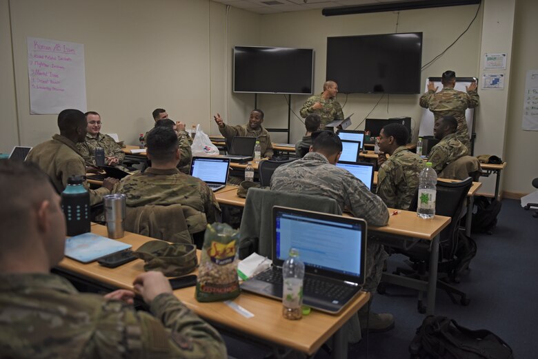 Airman Leadership School Class 20-A discuss negotiation tactics at Kunsan Air Base, Republic of Korea, Dec. 13, 2019. ALS is a five week-long Air Force professional military education course designed to develop junior enlisted service members into effective supervisors, leaders and NCOs. It is the first PME course that enlisted Airmen encounter during their Air Force career. (U.S. Air Force photo by Staff Sgt. Mackenzie Mendez)