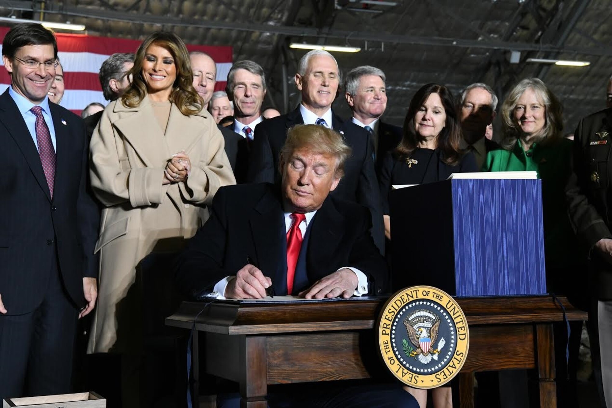 President Donald Trump signs S.1790, the National Defense Authorization Act for Fiscal Year 2020 as senior leaders look on, Friday, Dec. 20, 2019, at Joint Base Andrews, MAryland. The act authorizes a budget that supports the U.S. armed forces and postures the Air Force to meet the requirements of the National Defense Strategy.