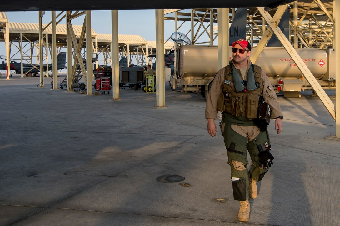 A U.S. Air Force pilot assigned to the 494th Expeditionary Fighter Squadron conducts a preflight inspection before take off for a fly-by over Doha, Qatar in honor of Qatar National Day, Dec. 18, 2019.