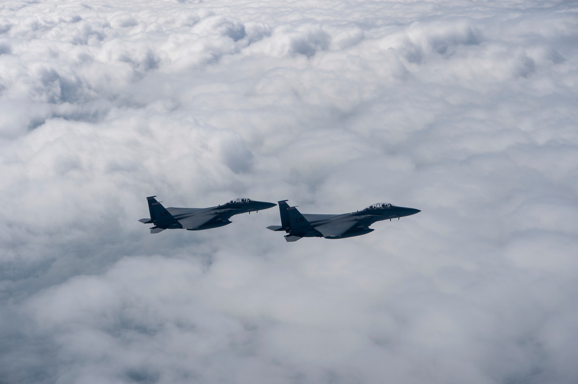 Two U.S. Air Force F-15E Strike Eagles assigned to the 494th Expeditionary Fighter Squadron, fly enroute to participate in a fly over honoring Qatar National Day, Dec. 18, 2019.