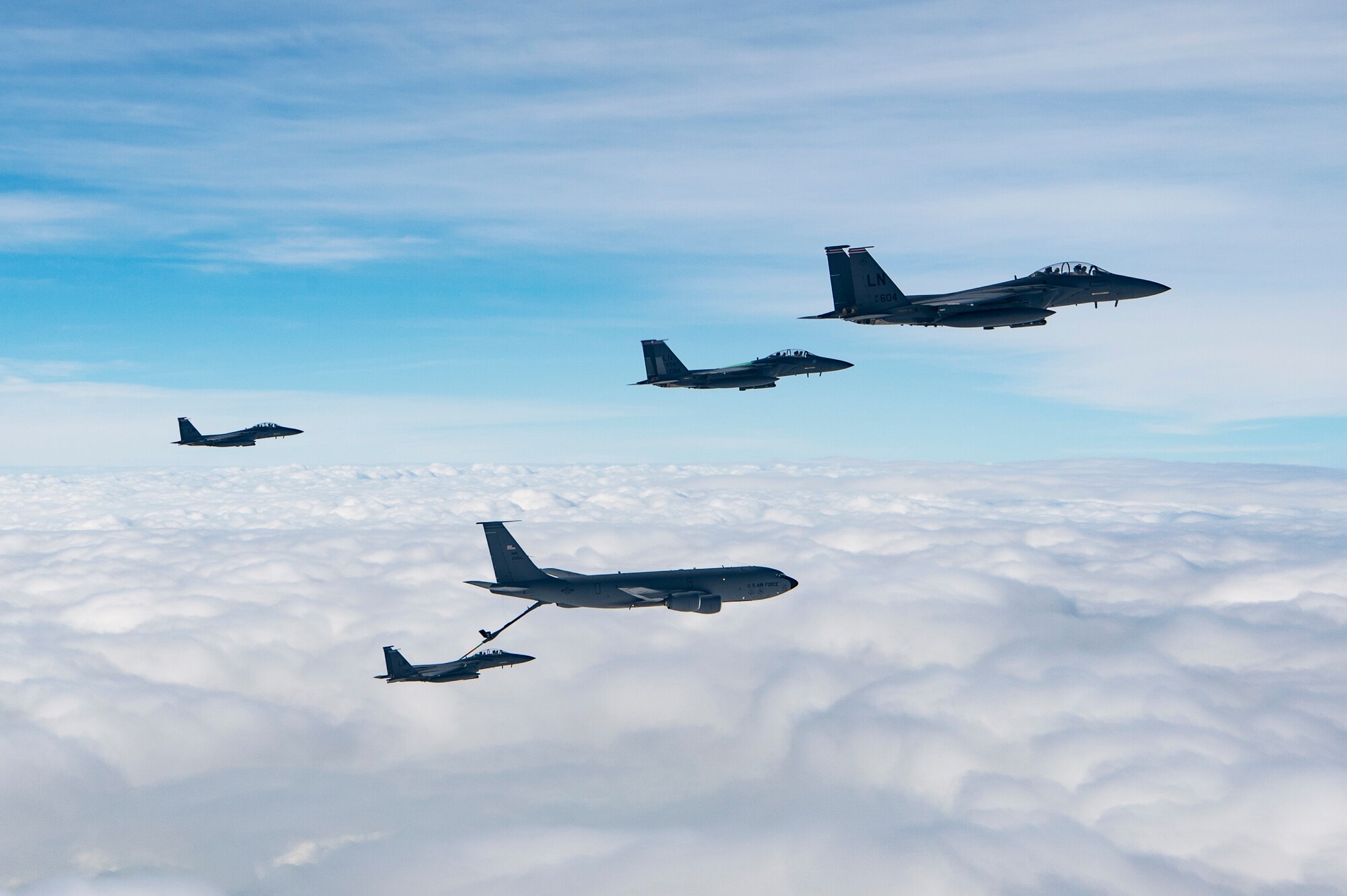 U.S. Air Force F-15E Strike Eagles assigned to the 494th Expeditionary Fighter Squadron, refuel from a KC-135 Stratotanker assigned to the 28th Expeditionary Air Refueling Squadron enroute to participate in a formation fly over honoring Qatar National Day, Dec. 18, 2019.