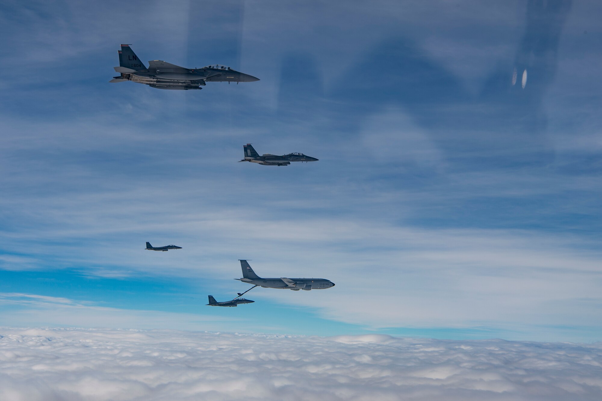 U.S. Air Force F-15E Strike Eagles assigned to the 494th Expeditionary Fighter Squadron, refuel from a KC-135 Stratotanker assigned to the 28th Expeditionary Air Refueling Squadron enroute to participate in a formation fly over honoring Qatar National Day, Dec. 18, 2019.