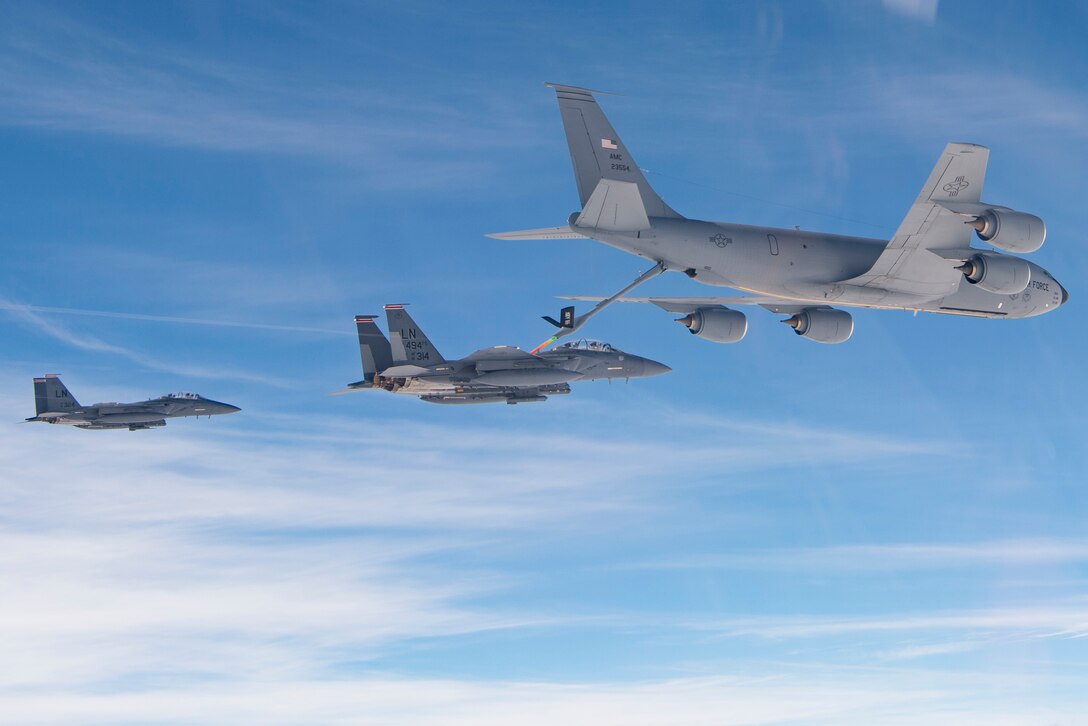 U.S. Air Force F-15E Strike Eagles assigned to the 494th Expeditionary Fighter Squadron, refuel from a KC-135 Stratotanker assigned to the 28th Expeditionary Air Refueling Squadron enroute to participate in a formation fly over honoring Qatar National Day, Dec. 18, 2019.