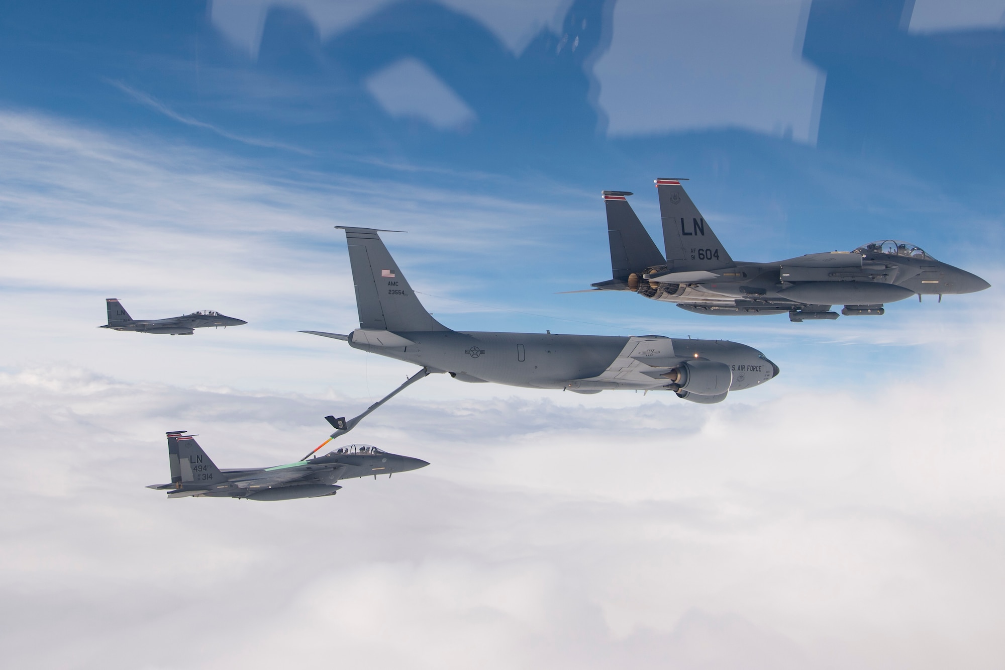 U.S. Air Force F-15E Strike Eagles assigned to the 494th Expeditionary Fighter Squadron, refuel from a KC-135 Stratotanker assigned to the 28th Expeditionary Air Refueling Squadron enroute to participate in a formation fly over honoring Qatar National Day, Dec. 18, 2019.