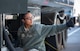 An gives a thumbs up while working on a refueling truck.