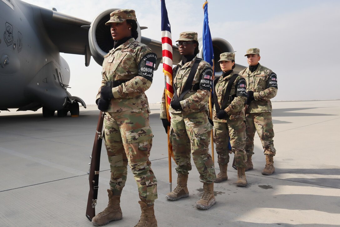 Honor Guard members assigned to the 379th Expeditionary Force Support Squadron stand ready to post the colors during the 385th Air Expeditionary Group change of command ceremony at Al Udeid Air Base, Qatar on Dec. 17, 2019. During the ceremony, Col. Christopher Lay relinquished command to Col. William Gutermuth.(U.S. Air Force photo by Tech. Sgt. Ian Dean)