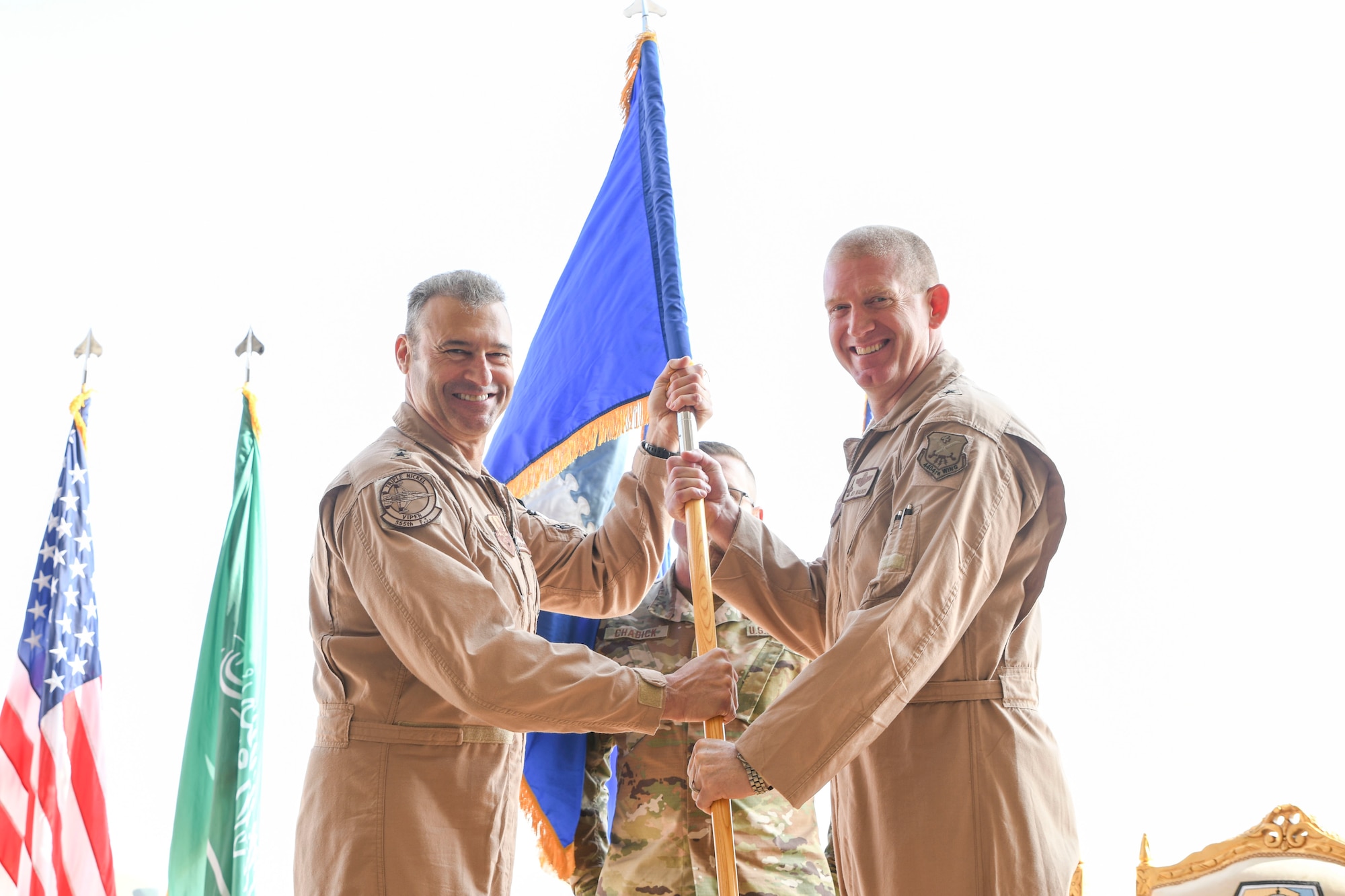 Prince Sultan Air Base, Kingdom of Saudi Arabia -- U.S. Air Force Lt. Gen. Joseph Guastella, Air Forces Central Command commander, presents Brig. Gen. John C. Walker, former deputy commander of the 9th Air and Space Expeditionary Task Force in Afghanistan, the guidon during the 378th Air Expeditionary Wing activation ceremony here, Dec. 17, 2019.