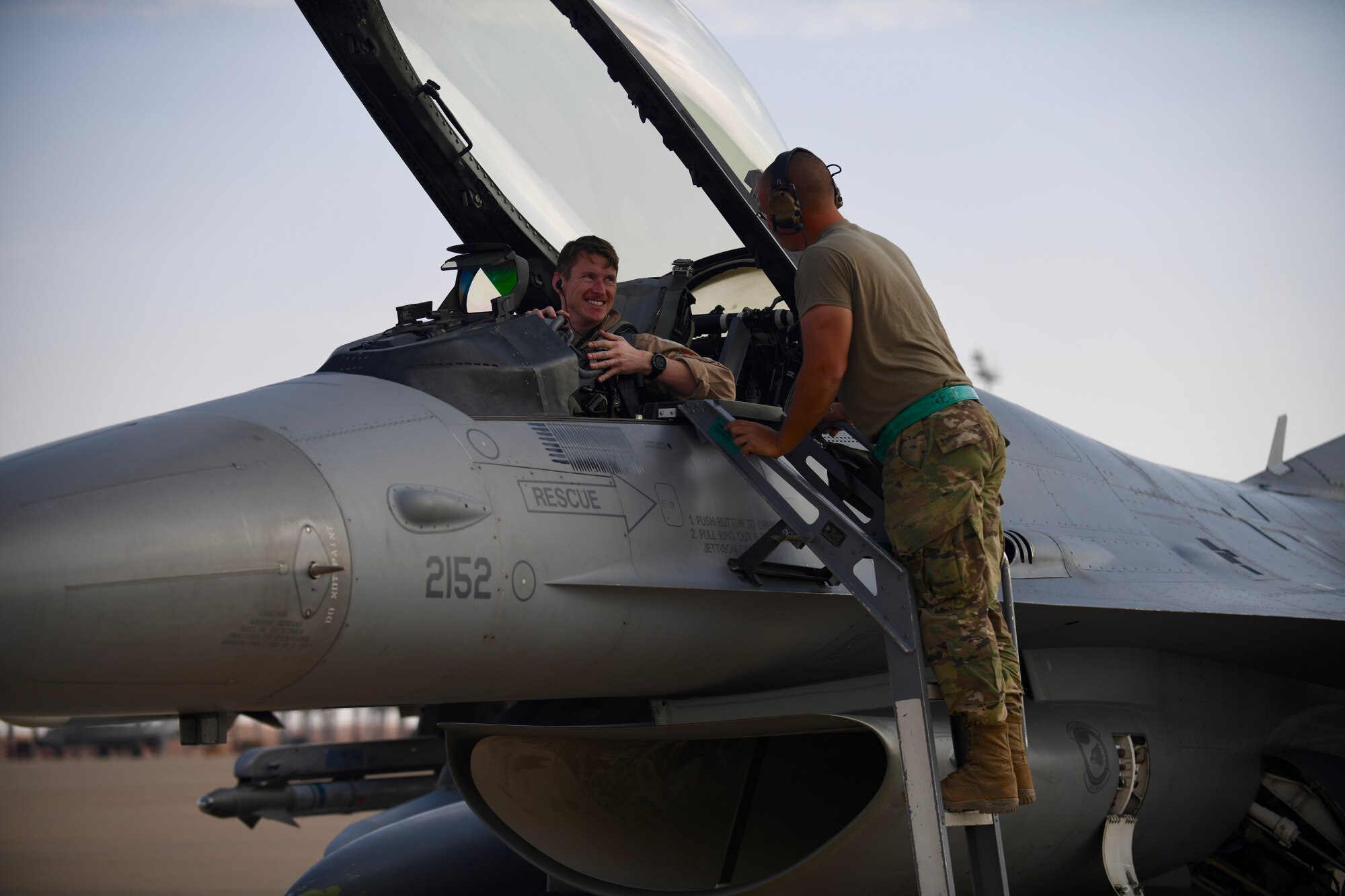 U.S. Air Force Senior Airman Donavan Finn, 555th Expeditionary Aircraft Maintenance Unit crew chief, chats with an F-16 Fighting Falcon pilot, assigned to the 555th Expeditionary Fighter Squadron, Dec. 2, 2019 during a forward deployment to Prince Sultan Air Base, Saudi Arabia.