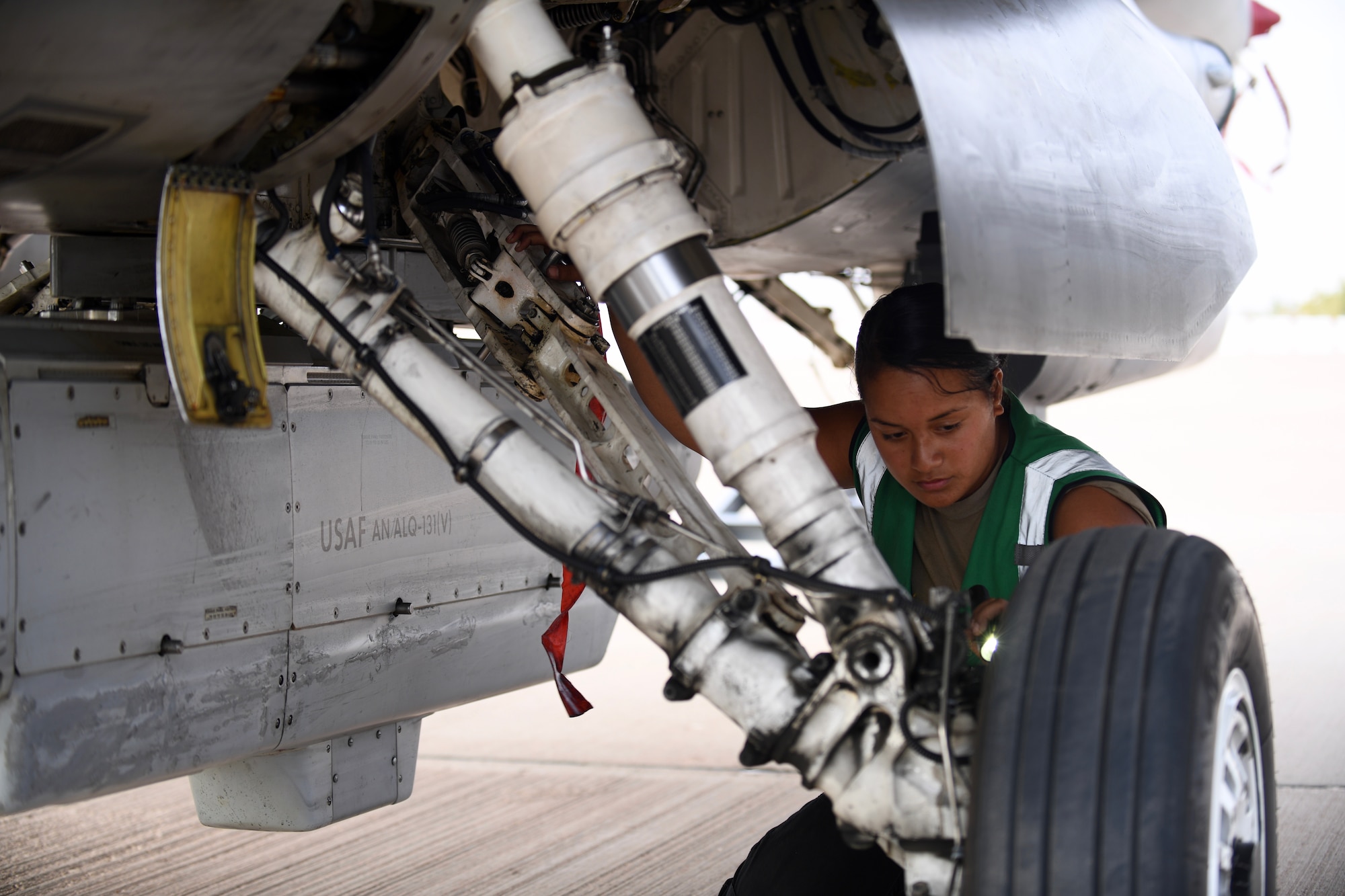 U.S. Air Force Airman 1st Class Caitlyn Reid, 555th Expeditionary Aircraft Maintenance Unit crew chief, inspects an F-16 Fighting Falcon, assigned to the 555th Expeditionary Fighter Squadron, Dec. 2, 2019 at Prince Sultan Air Base, Saudi Arabia.