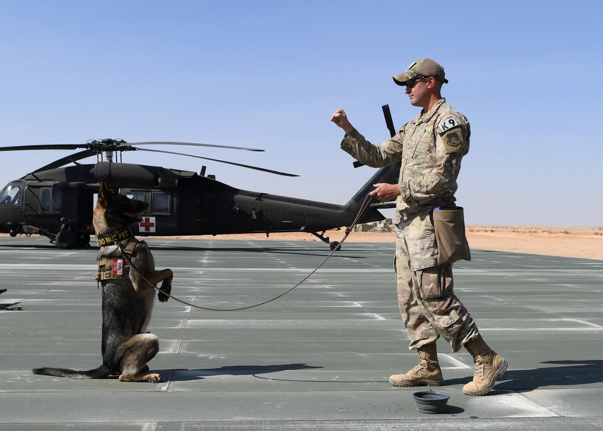 U.S. Air Force Staff Sgt. Daniel Duarte, 378th Expeditionary Security Forces Squadron K-9 handler, and his military working dog, Tuko, practice obedience skills Nov. 27, 2019, at Prince Sultan Air Base, Saudi Arabia.