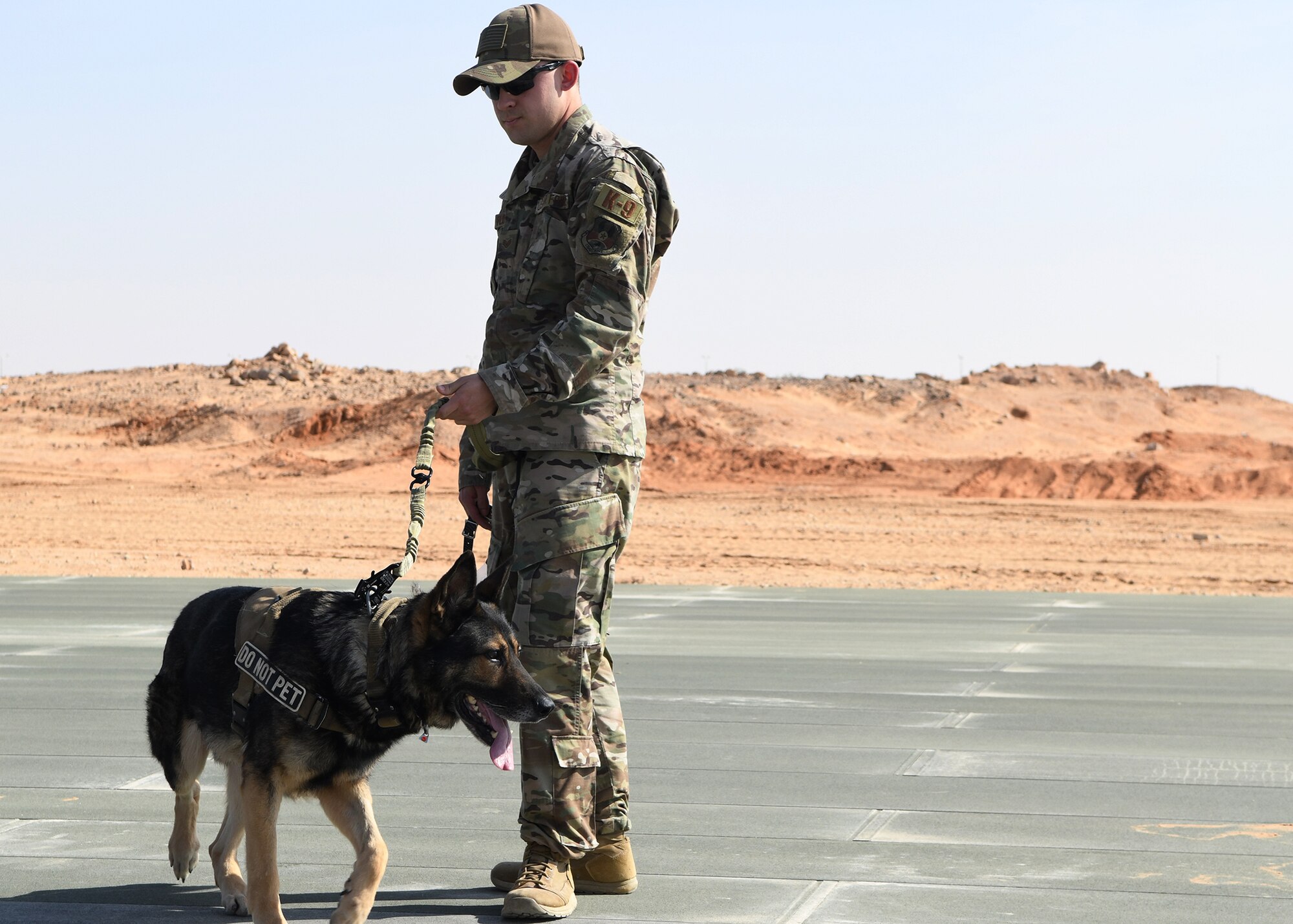 U.S. Air Force Staff Sgt. Zach Floto, 378th Expeditionary Security Forces Squadron K-9 handler, waits with his military working dog, Robi, for a medical evacuation training Nov. 27, 2019, at Prince Sultan Air Base, Saudi Arabia.