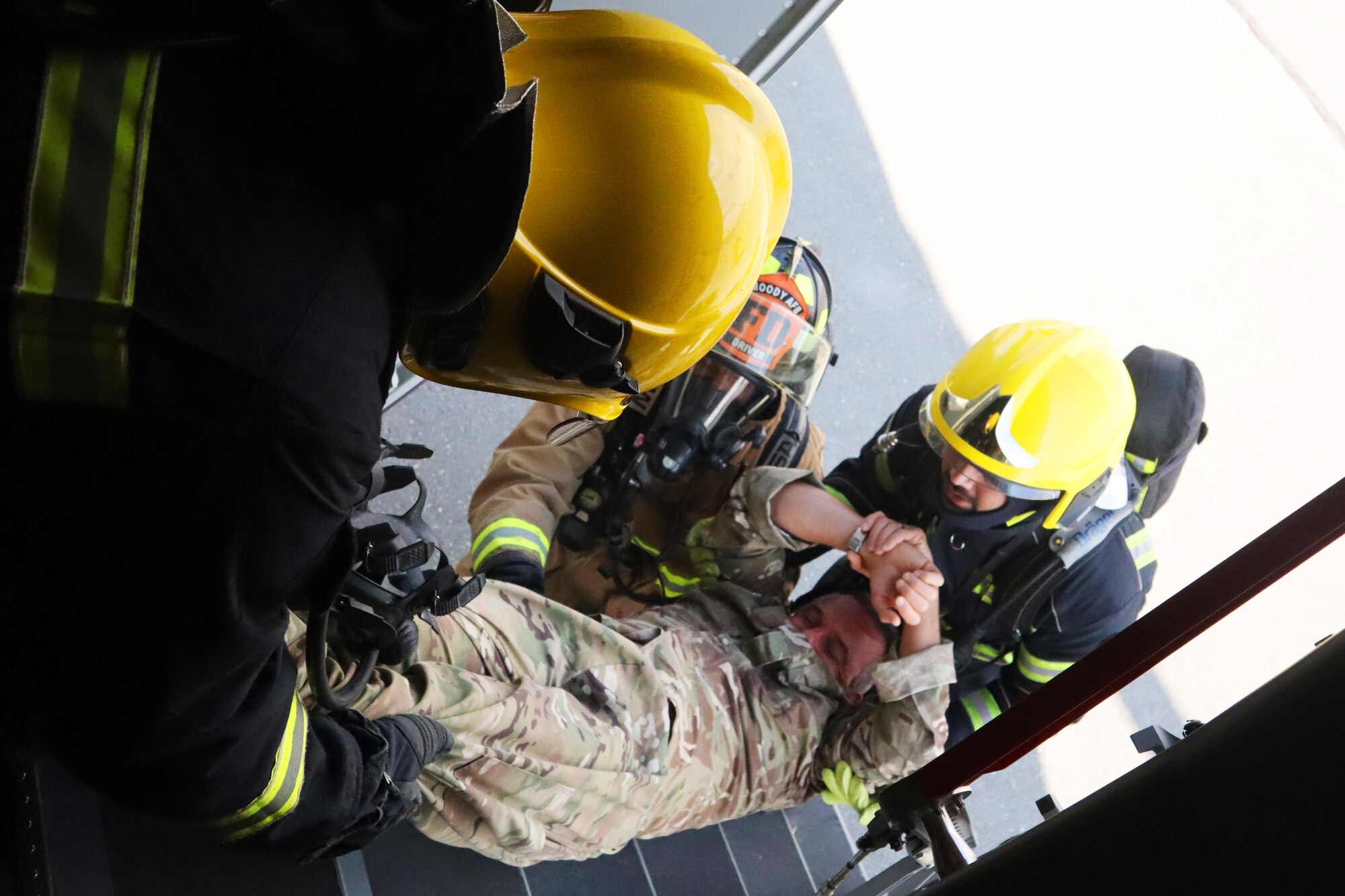 Firefighters from the 379th Expeditionary Civil Engineer Squadron and Qatar Emiri Air Force move a simulated patient from a Royal Air Force A400m Atlas aircraft during a major accident response exercise at Al Udeid Air Base, Qatar on Nov. 12, 2019. The MARE was developed by U.S. Air Force and Royal Air Force planners in order to increase coalition partner interoperability during an emergency situation.(U.S. Air Force photo by Tech. Sgt Ian Dean)