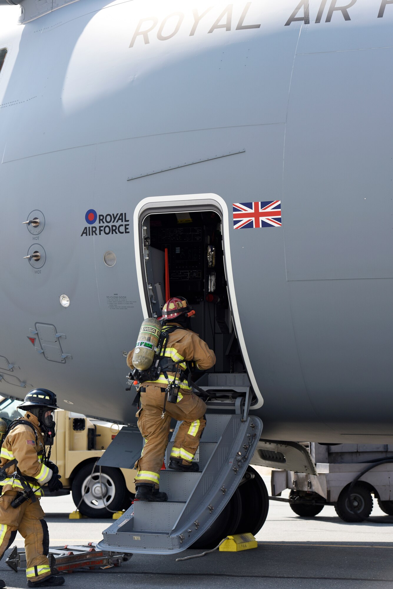 Firefighters from the 379th Expeditionary Civil Engineer Squadron enter a Royal Air Force A400M Atlas aircraft during a major accident response exercise at Al Udeid Air Base, Qatar on Nov. 12, 2019. The MARE was developed by U.S. Air Force and RAF planners in order to increase coalition partner interoperability during an emergency situation.(U.S. Air Force photo by Tech. Sgt. Ian Dean)