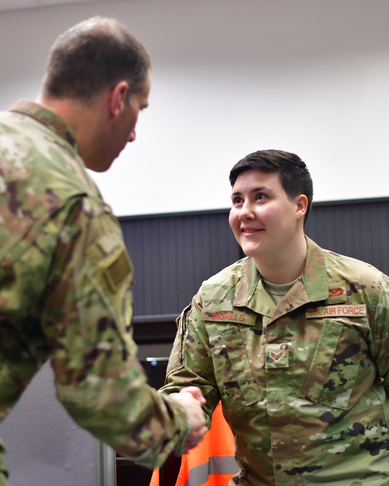 U.S. Air Force Col. Matt S. Husemann, 86th Airlift Wing vice commander, congratulates Senior Airman Ariana M. Ingalls, 786th Civil Engineer Squadron pavement and equipment journeyman, for being named Airlifter of the Week at Ramstein Air Base, Germany, Dec. 19, 2019. Ingalls worked on preventive maintenance, work requests and projects that helped keep up 5.9 million square yards of pavement, 86 miles of roads and 26 miles of perimeter fencing across the installation. (U.S. Air Force photo by Airman 1st Class John R. Wright)