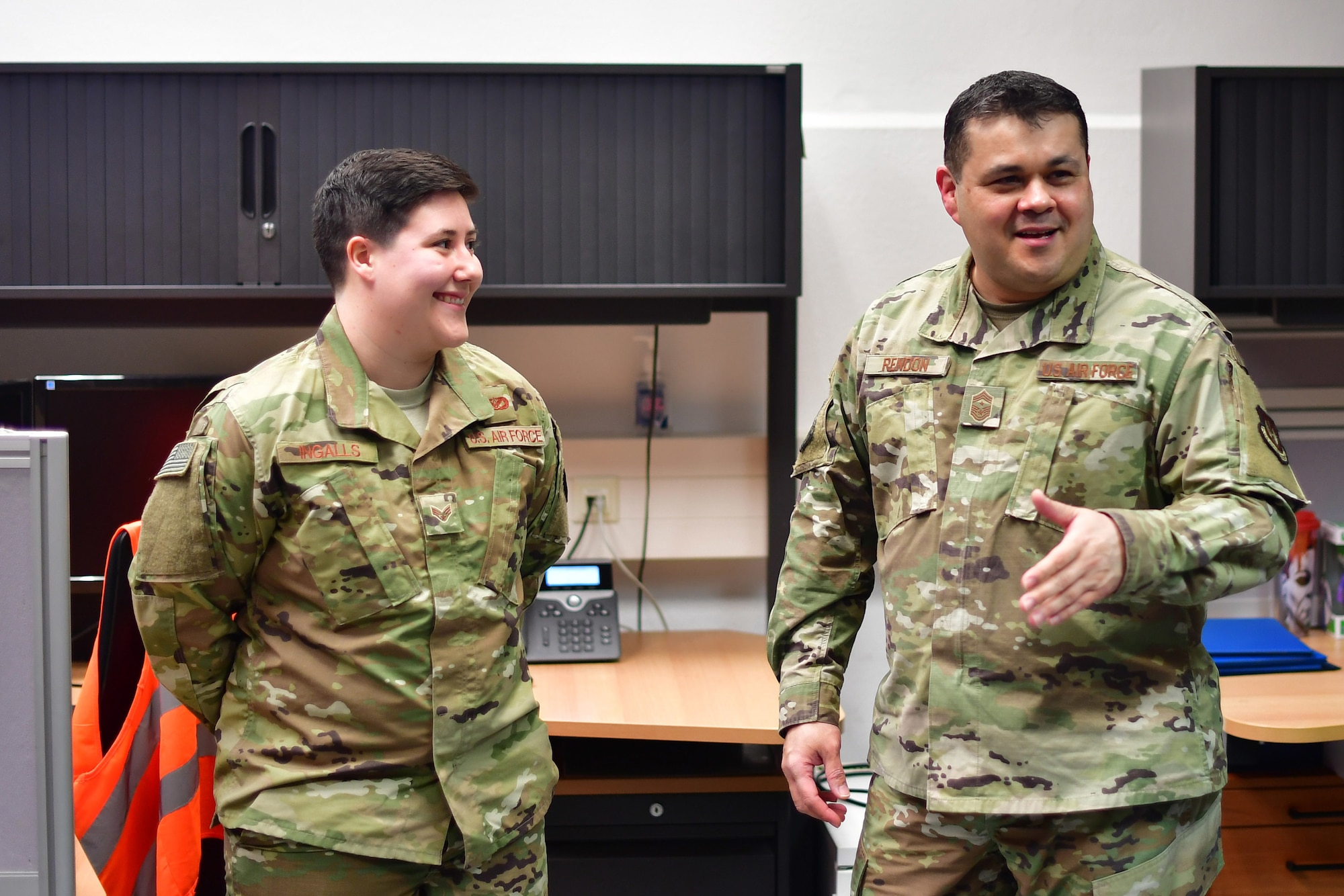 U.S. Air Force Chief Master Sgt. Ernesto J. Rendon, 86th Airlift Wing command chief, talks about the accomplishments of Senior Airman Ariana M. Ingalls, 786th Civil Engineer Squadron pavement and equipment journeyman, after recognizing Ingalls as Airlifter of the Week at Ramstein Air Base, Germany, Dec. 19, 2019. Ingalls dedicates time outside of work to volunteer projects that raise money for college scholarships given to Kaiserslautern Military Community high school students. (U.S. Air Force photo by Airman 1st Class John R. Wright)