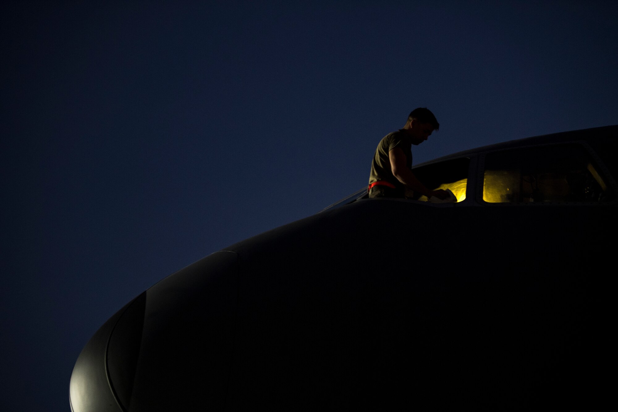 A U.S. Air Force KC-10 Extender crew chief assigned to the 380th Expeditionary Aircraft Maintenance Squadron cleans a jet’s window, at Al Dahfra Air Base, United Arab Emirates Dec. 17, 2019.