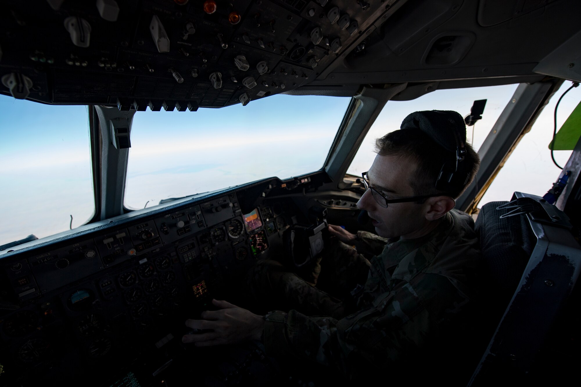 A U.S. Air Force KC-10 Extender pilot with the 908th Expeditionary Air Refueling Squadron(EARS) from Al Dhafra Air Base (ADAB), United Arab Emirates, adjusts aircraft settings while flying in support of Operation Inherent Resolve, Dec. 17, 2019.