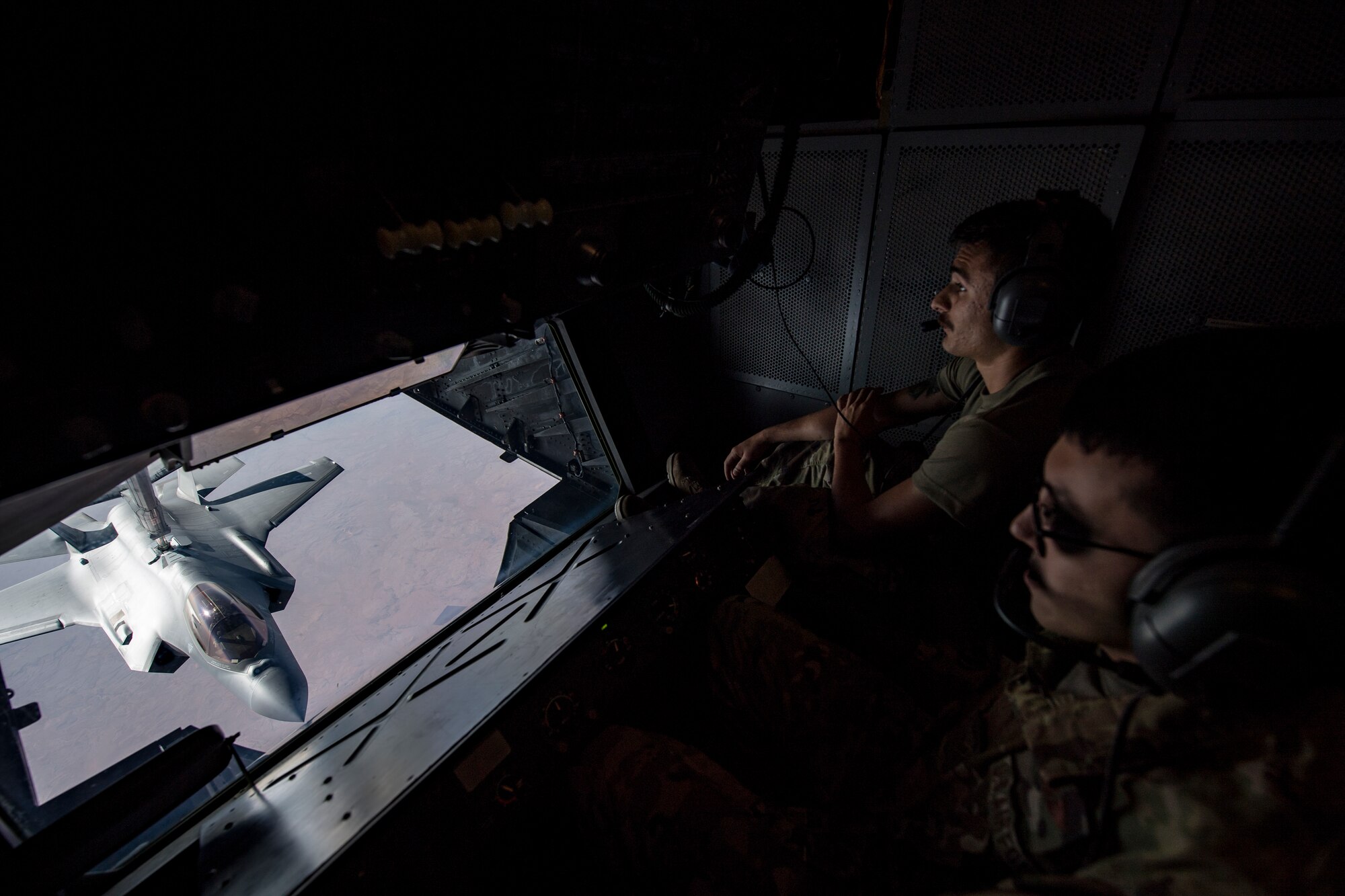 A U.S. Air Force KC-10 Extender boom operator with the 908th Expeditionary Air Refueling Squadron (EARS) from Al Dhafra Air Base (ADAB), United Arab Emirates, conducts an aerial refueling with a U.S. Air Force F-35A Lightning II assigned to the 34th Expeditionary Fighter Squadron, also from ADAB, in support of Operation Inherent Resolve, Dec. 17, 2019.