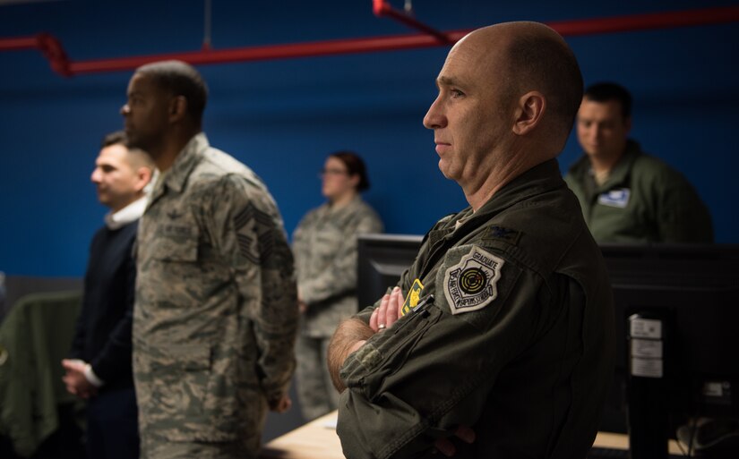 U.S. Air Force Col. Steve Fino, 1st Fighter Wing vice wing commander, watches as the ribbon is cut at the opening ceremony of the innovation lab at Joint Base Langley-Eustis, Virginia, Dec. 17, 2019. The lab is meant to be used as a tool to improve mission readiness by enhancing creativity for problem solving. (U.S. Air Force photo by Airman 1st Class Sarah Dowe)