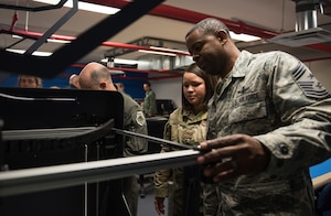 1st Fighter Wing command chief, opens a 3D printer at Joint Base Langley-Eustis, Virginia, Dec. 17, 2019. The innovation lab was opened with a ribbon cutting ceremony earlier that afternoon. (U.S. Air Force photo by Airman 1st Class Sarah Dowe)