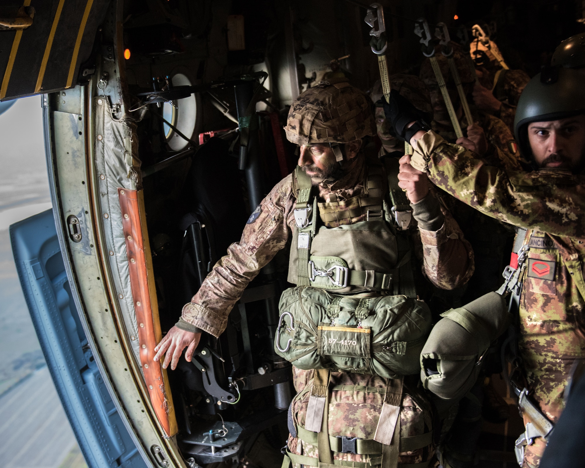 Members of the Italian Folgore, an airborne paratrooper brigade from the Italian Army, work to execute an airdrop mission alongside members of the Kentucky Air National Guard’s 123rd Airlift Wing in Pisa, Italy, Nov. 7, 2019. The mission was part of Mangusta 19, a bi-lateral exercise designed to promote readiness and interoperability among NATO allies. (U.S. Air National Guard photo by Senior Airman Chloe Ochs)