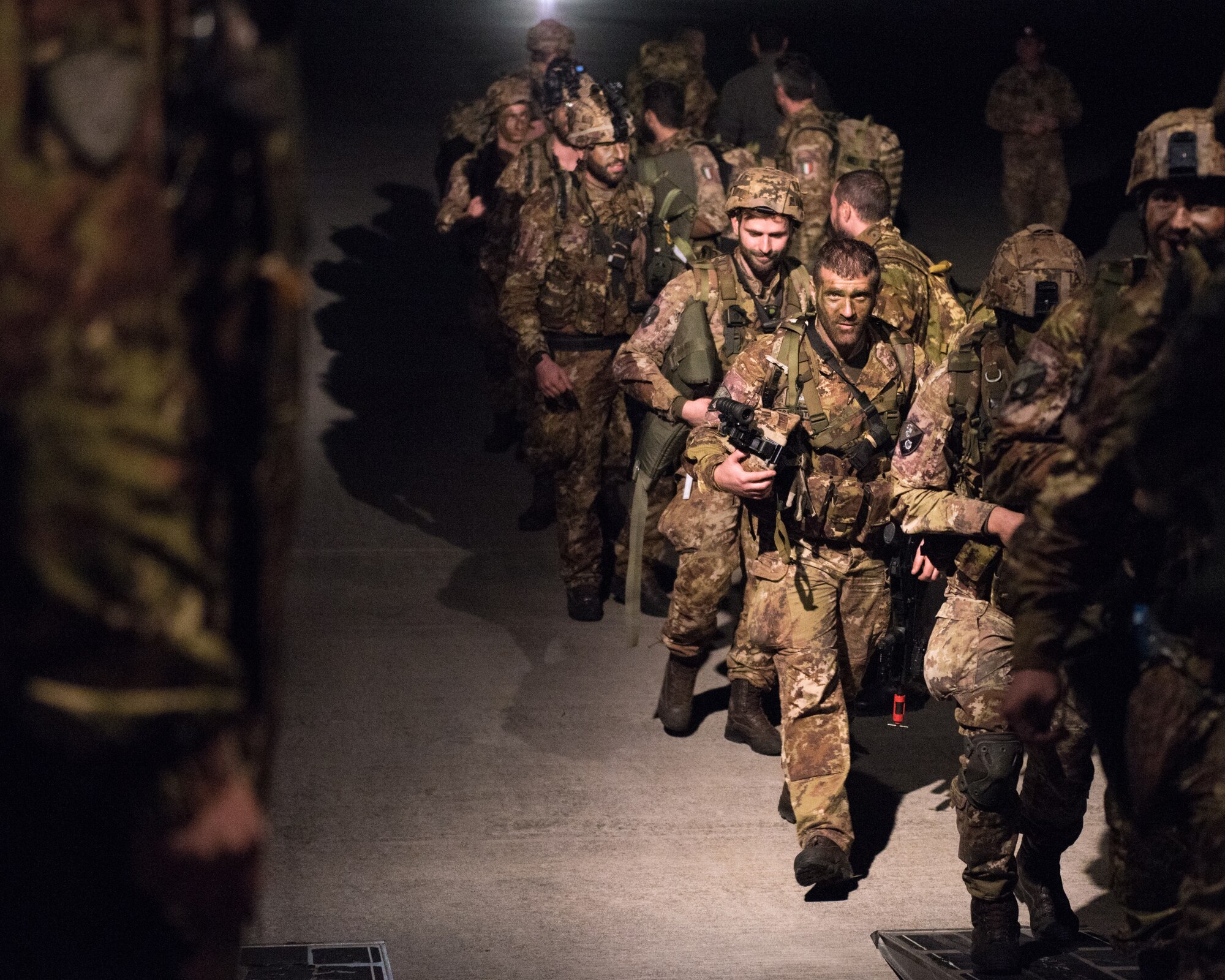 Members of the Italian Folgore, an airborne paratrooper brigade from the Italian Army, return from executing an air drop mission with members of the Kentucky Air National Guard’s 123rd Airlift Wing in Pisa, Italy, on Nov. 7, 2019. The mission was part of Mangusta 19, a bi-lateral exercise designed to promote readiness and interoperability among NATO allies. (U.S. Air National Guard photo by Senior Airman Chloe Ochs)