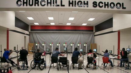 Wounded warrior active duty service members and veterans lock in on their targets during the inaugural United Warrior Air Rifle Competition at the Churchill high school Navy Junior ROTC building in San Antonio Dec. 10. UWAR is a quarterly adaptive reconditioning competition for veterans and active duty service members who are rehabilitating from a wound, injury or illness.