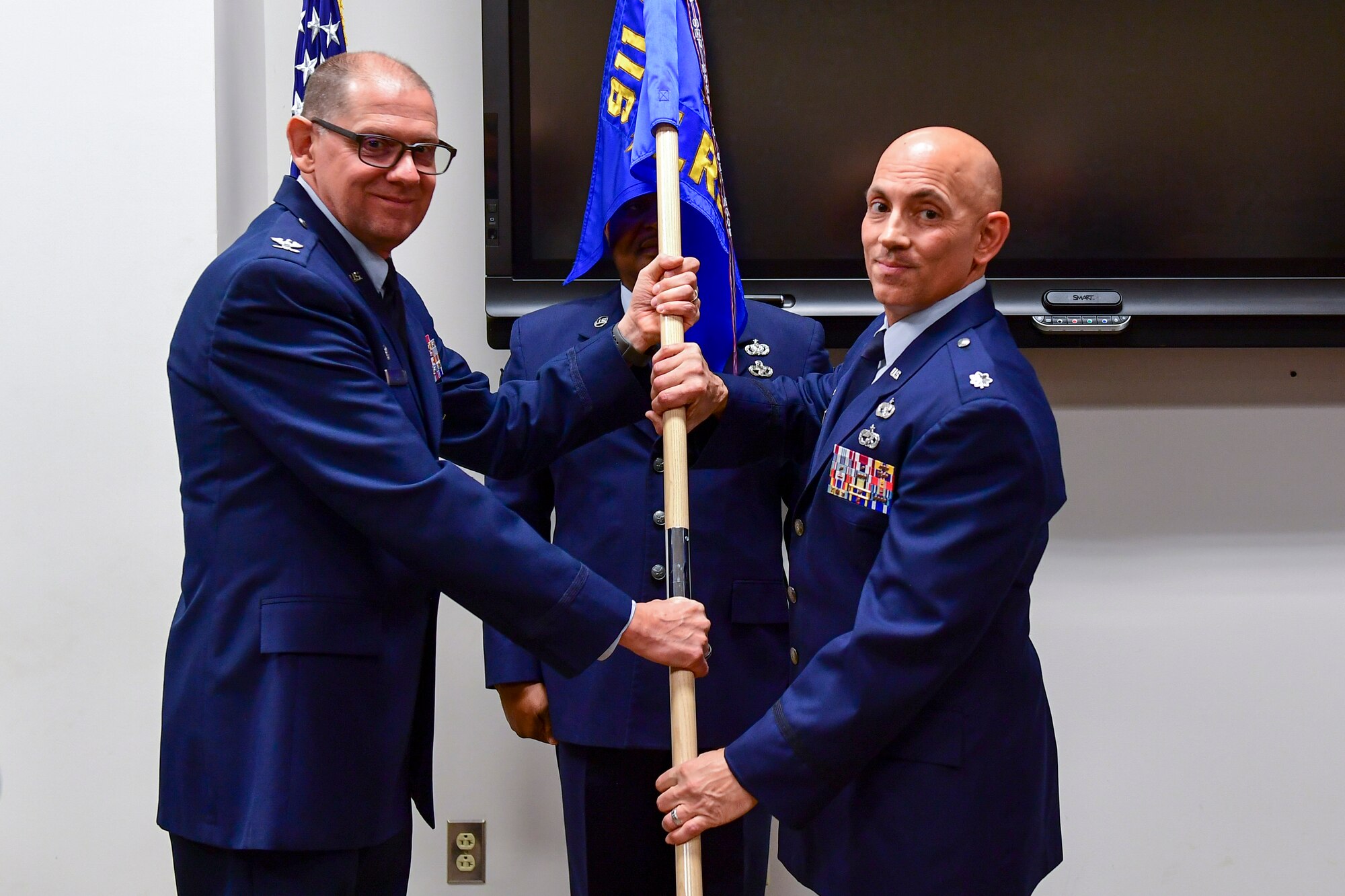 Lt. Col. Frank Mercurio, right, accepts the 911th Logistics Readiness Squadron guidon from 911th Mission Support Group Commander Col. Kenneth Lute during an assumption of command ceremony at the Pittsburgh International Airport Air Reserve Station, Pa., Dec. 7, 2019.