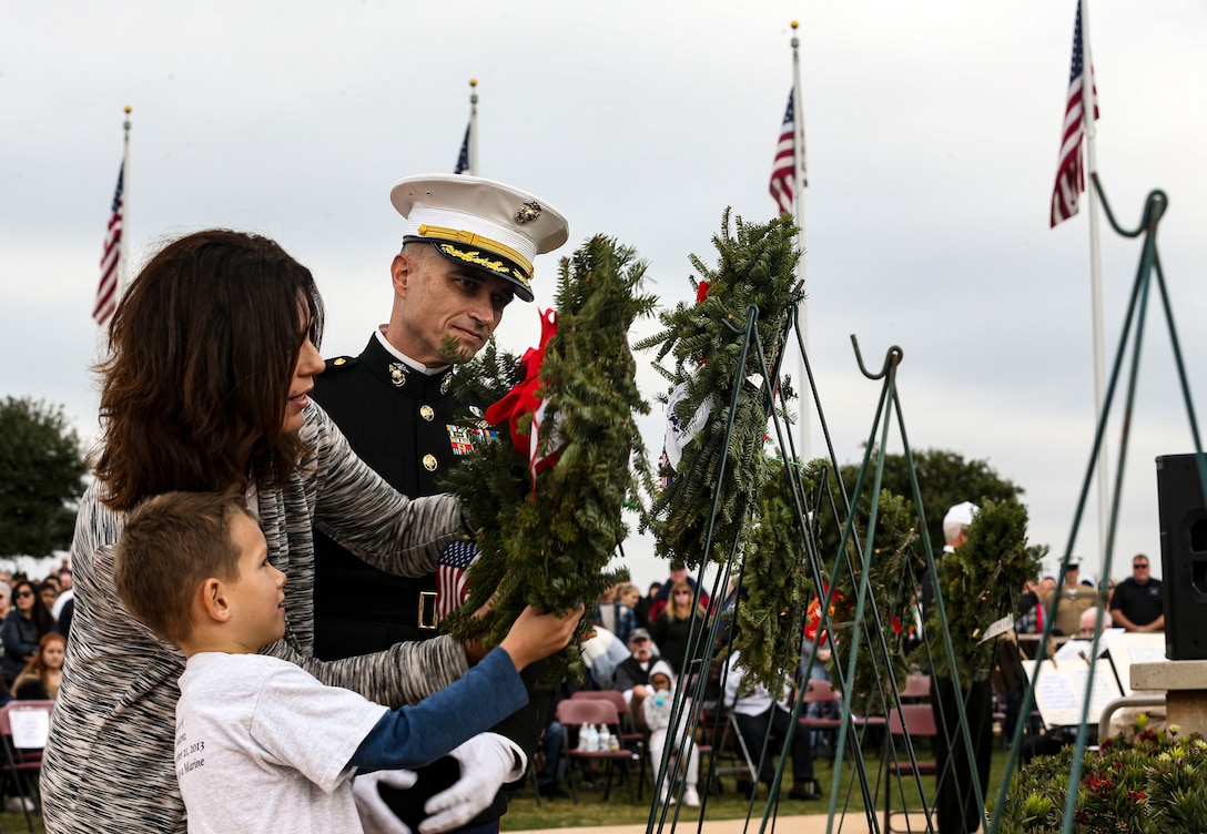 AJ Budenz, Gold Star family member, stands by his mother's side after laying a wreath on behalf of all the Gold Star Families who lost their loved ones  in San Diego, Dec. 14, 2019. The surrounding San Diego community gathered for Miramar National Cemetery’s annual Wreaths Across America ceremony to give their support to friends and family who have  lost loved ones.