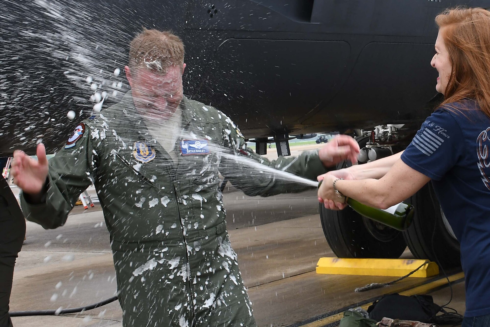 Lt. Col. Bailey being sprayed with water.