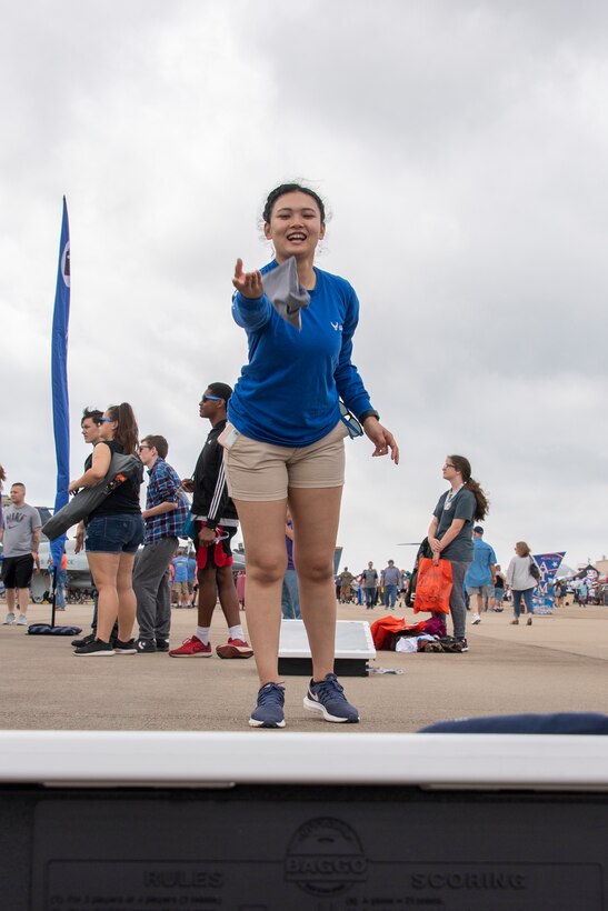 Photo of girl playing cornhole.