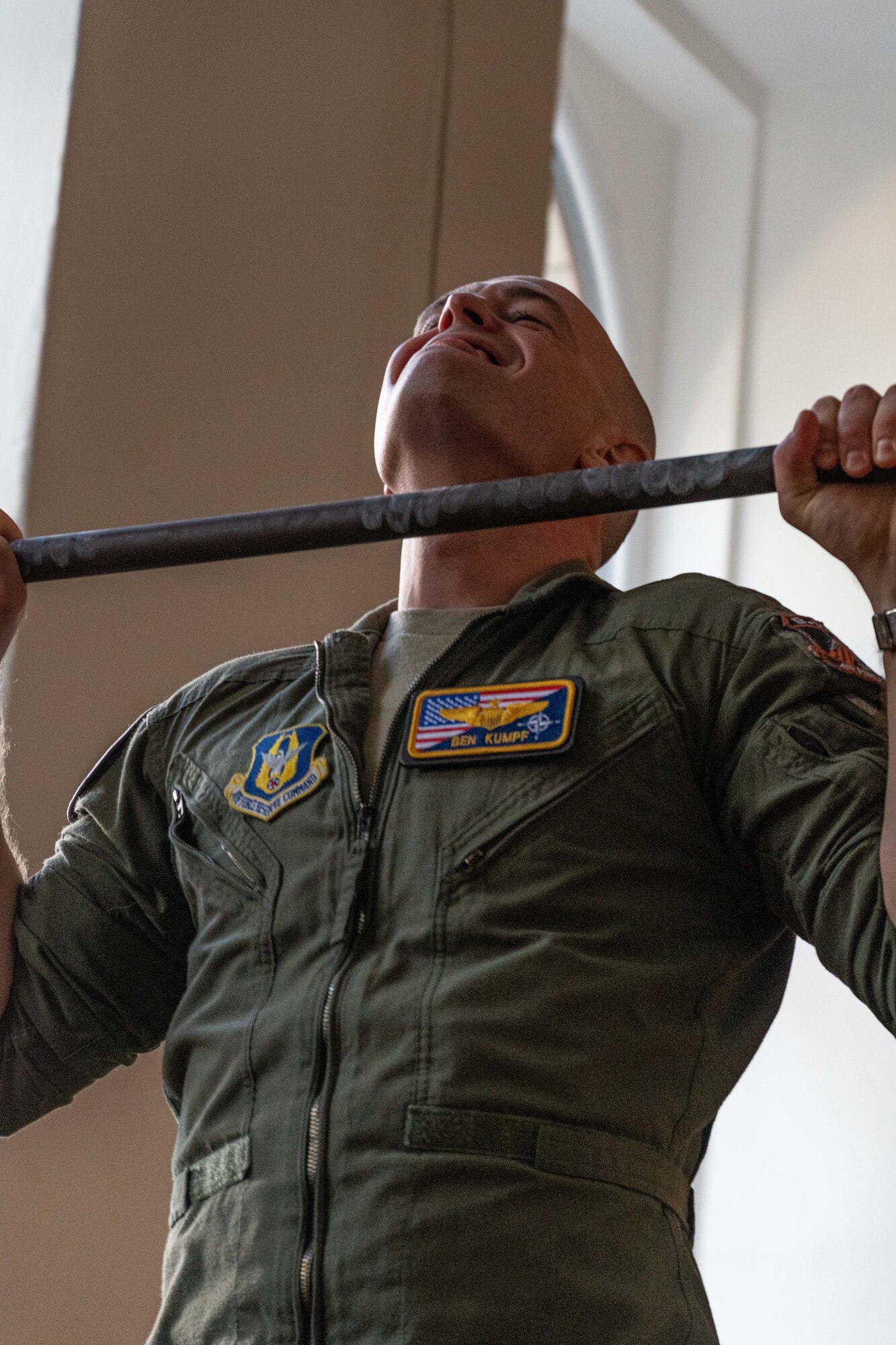 Photo of Airman performing a pull up
