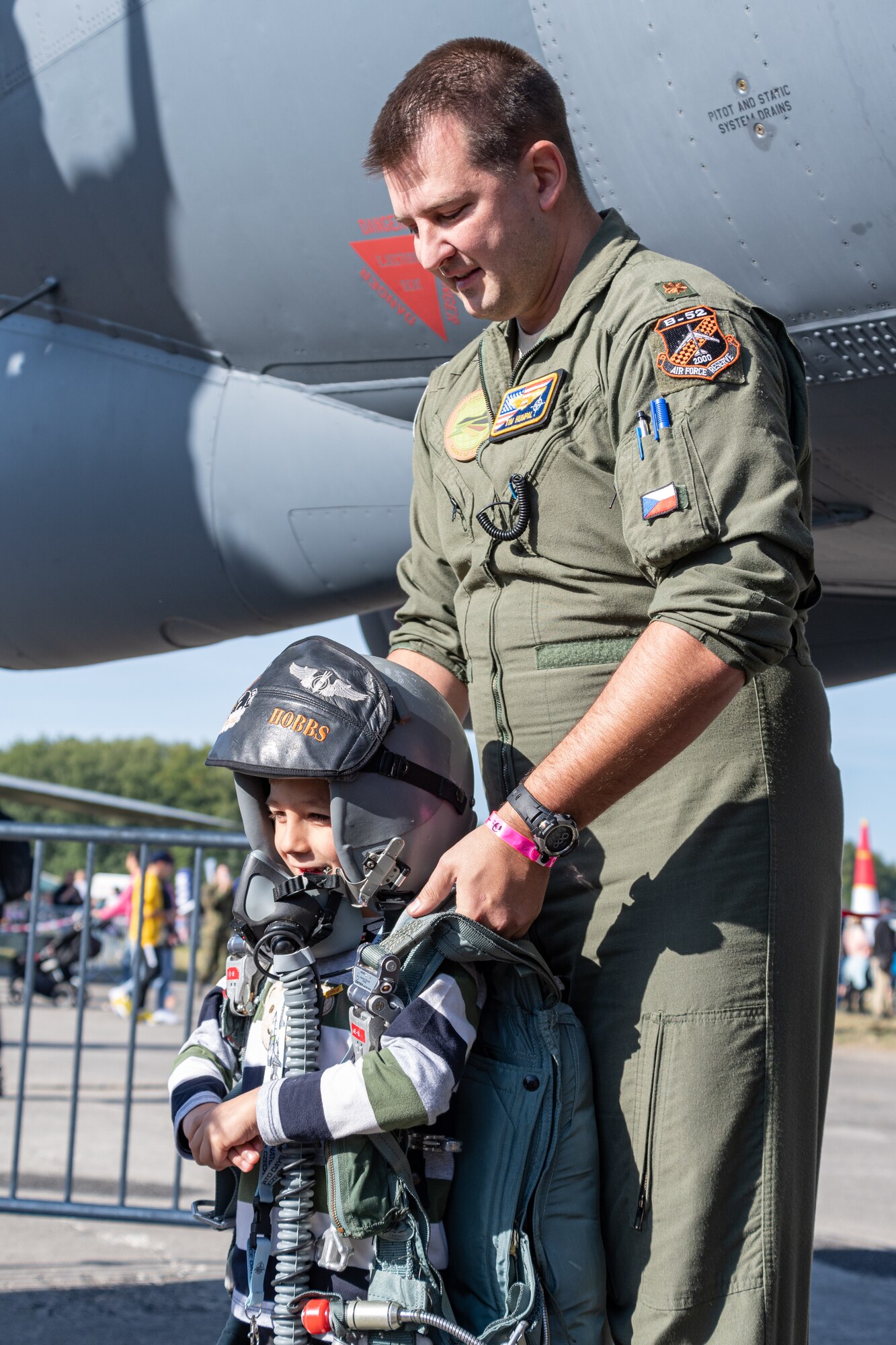 Photo of Airman helping child at air show.